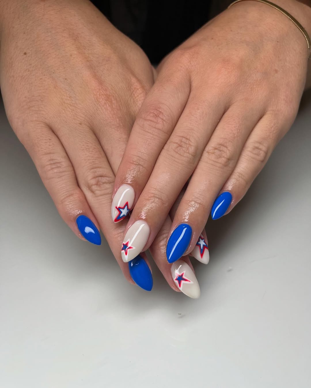 Blue and Creamy White Starburst Fourth of July Almond Nails